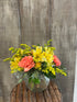 Yellow flowers with pops of coral make for the perfect arrangement sure to brighten any day.
