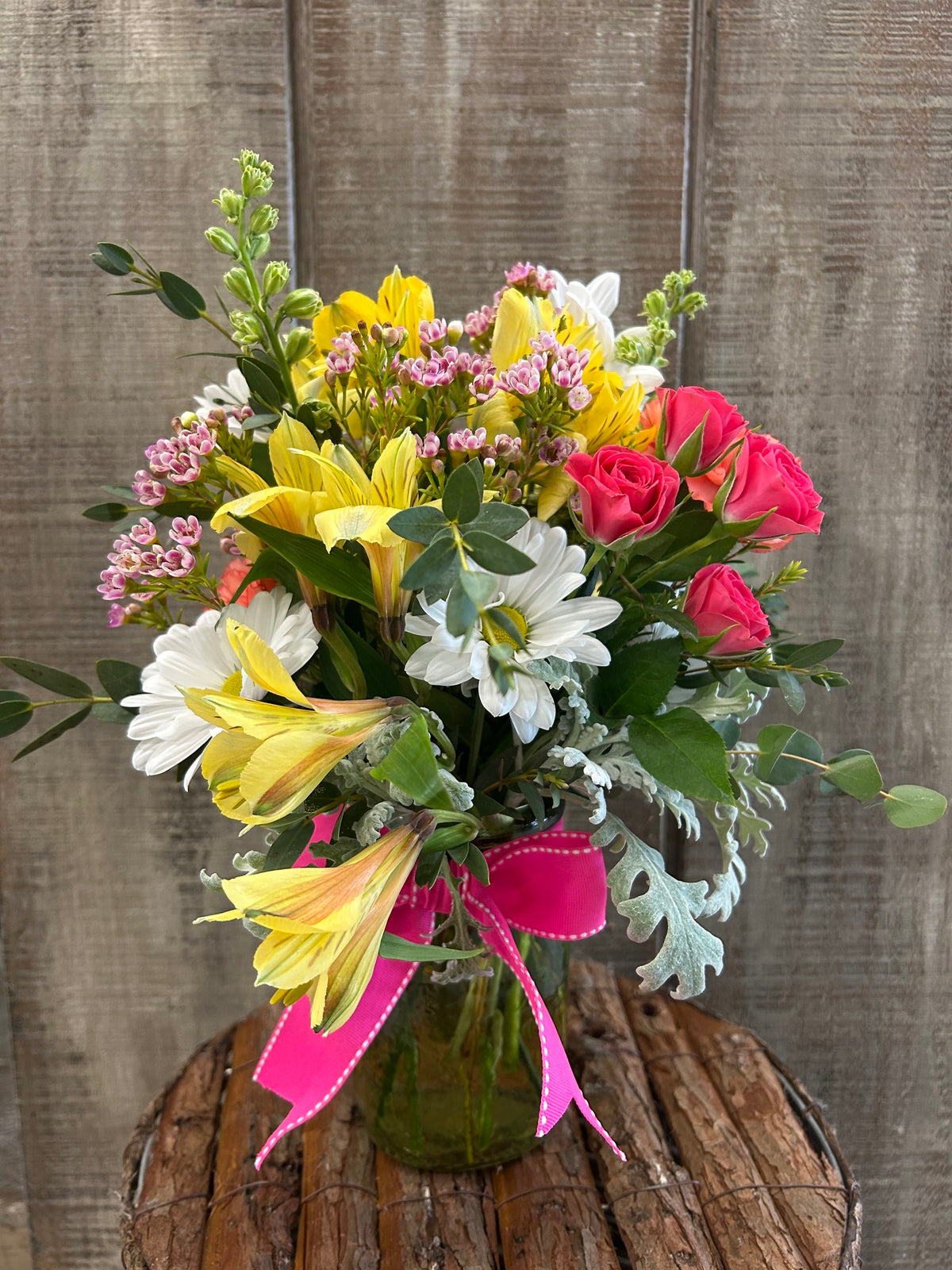 a colorful arrangement with pink and yellow flowers