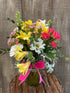 a colorful arrangement with pink and yellow flowers